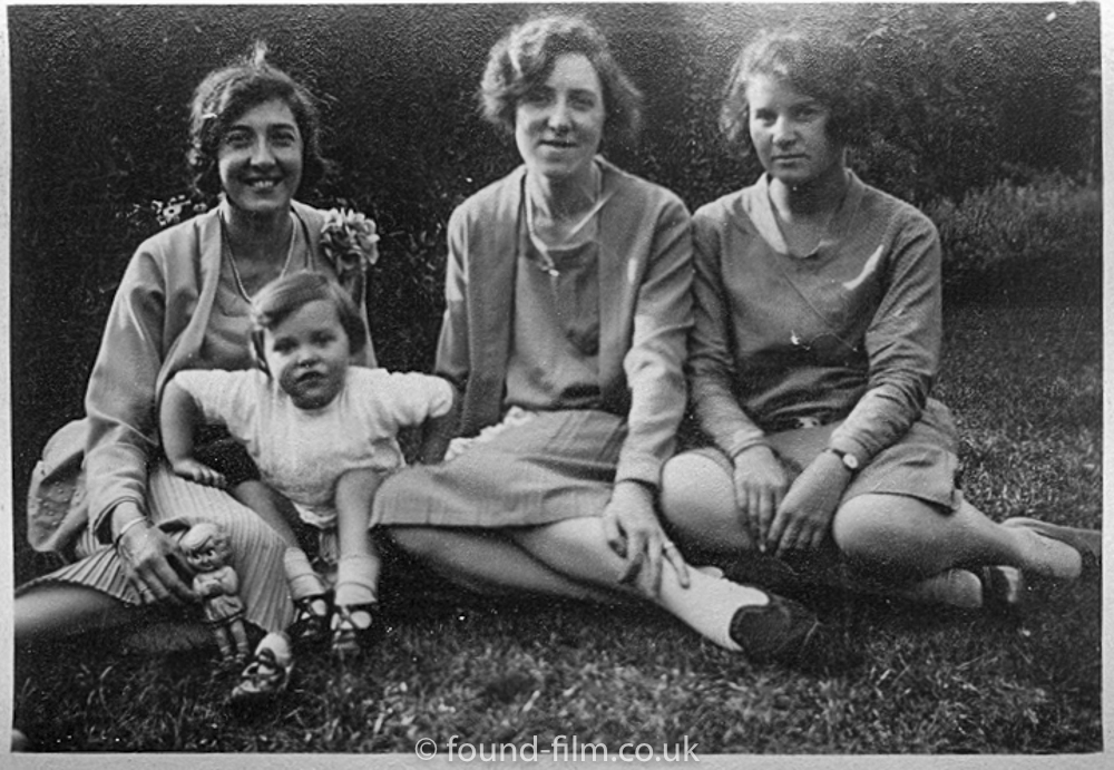 Three womin and a child in a family group from the 1920s