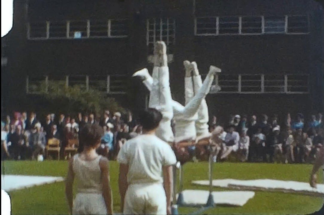 A still image from an Ilford 8mm film of an athletics display, possibly at a public school in the 1960s