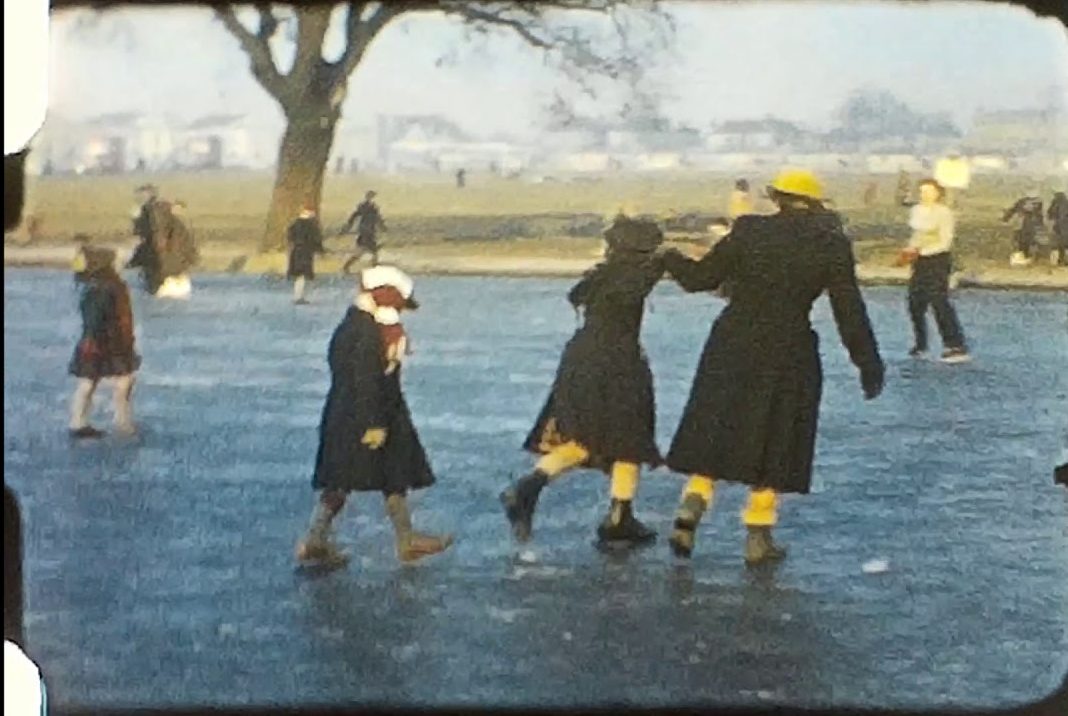 A picture of people Ice Skating from a vintage home movie from 1956