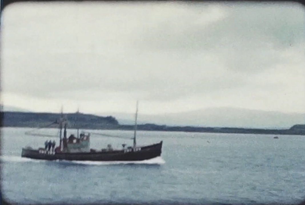 A still image of a boat which was taken from a vintage home movie of Oban in Scotland in 1958