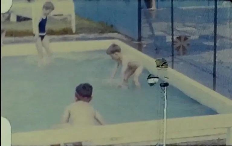 A still image from a vintage home movie taken by a family enjoying a caravan holiday in the 1960s