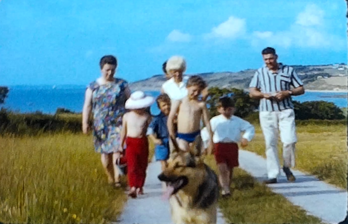 A still image from a vintage home movie showing a family on holday by the seaside