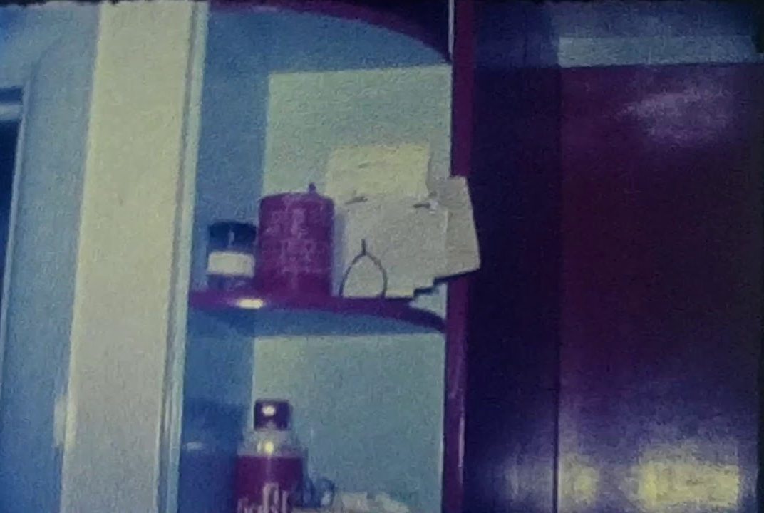 A still image from a vintage home movie showing a walk through of a home makeover 1960s style