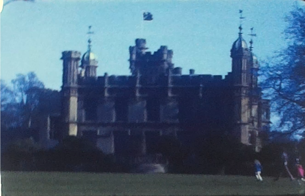 A still image from a vintage home movie showing Knebworth House in Hertfordshire