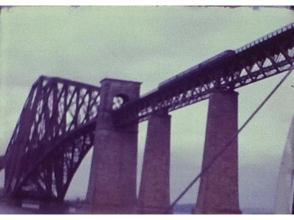 A Still image from a vintage home movie showing the forth rail bridge