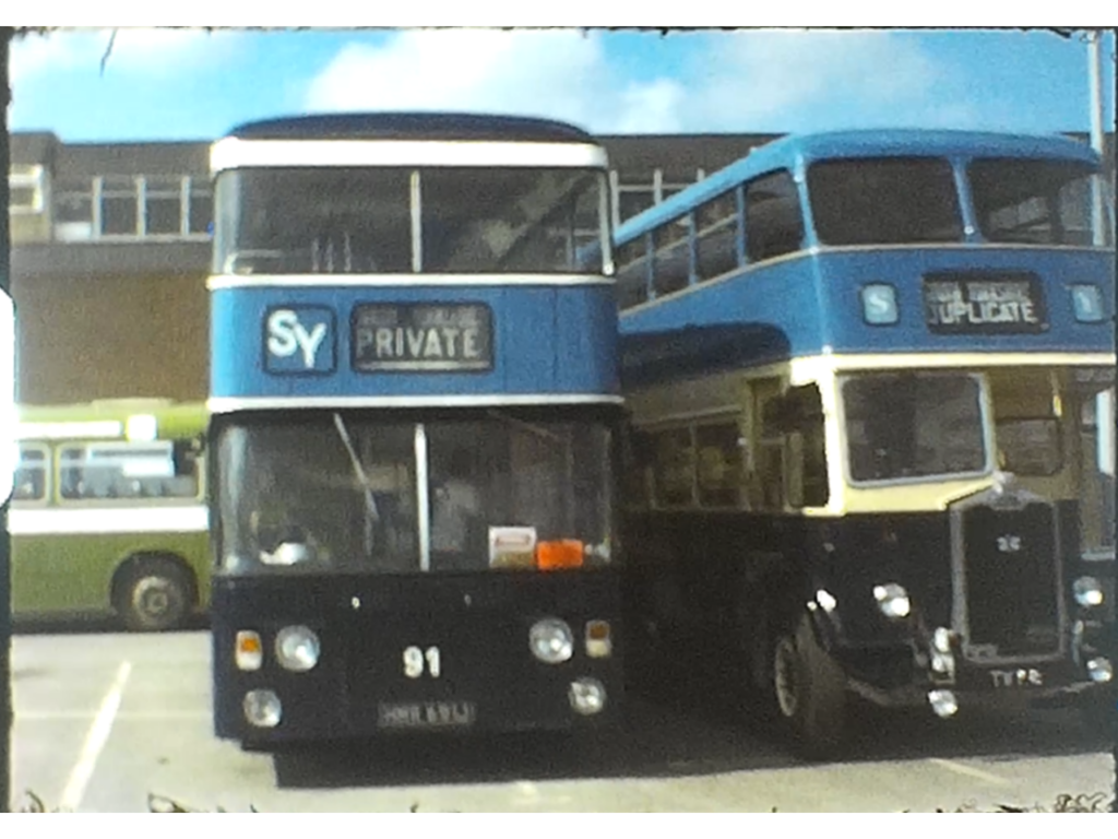 A Still image from a Super 8 vintage home movie taken in a bus museum