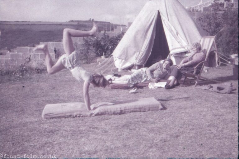 A Girl performing gymnastics on the lawn c1955