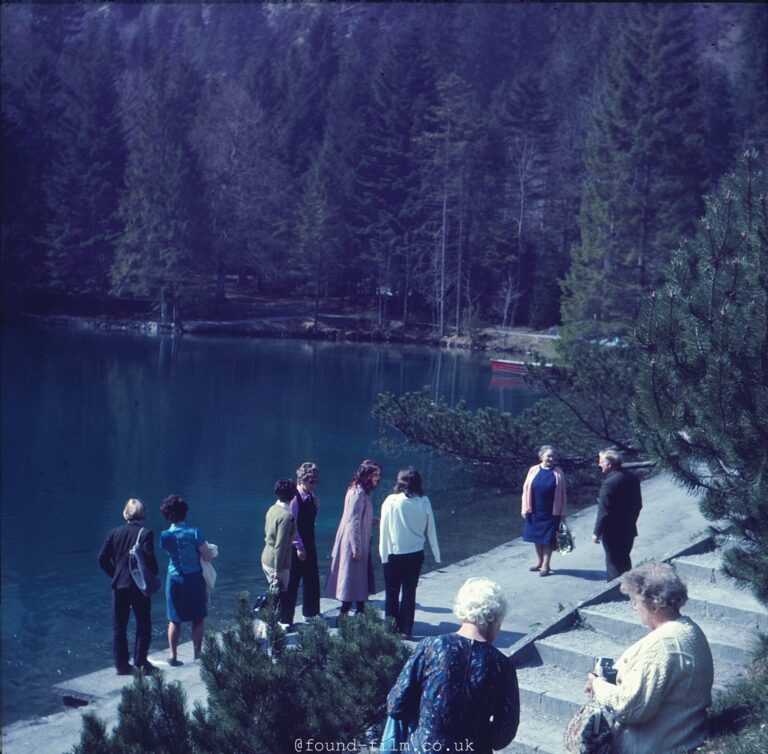 A Group standing by a lake and admiring the view