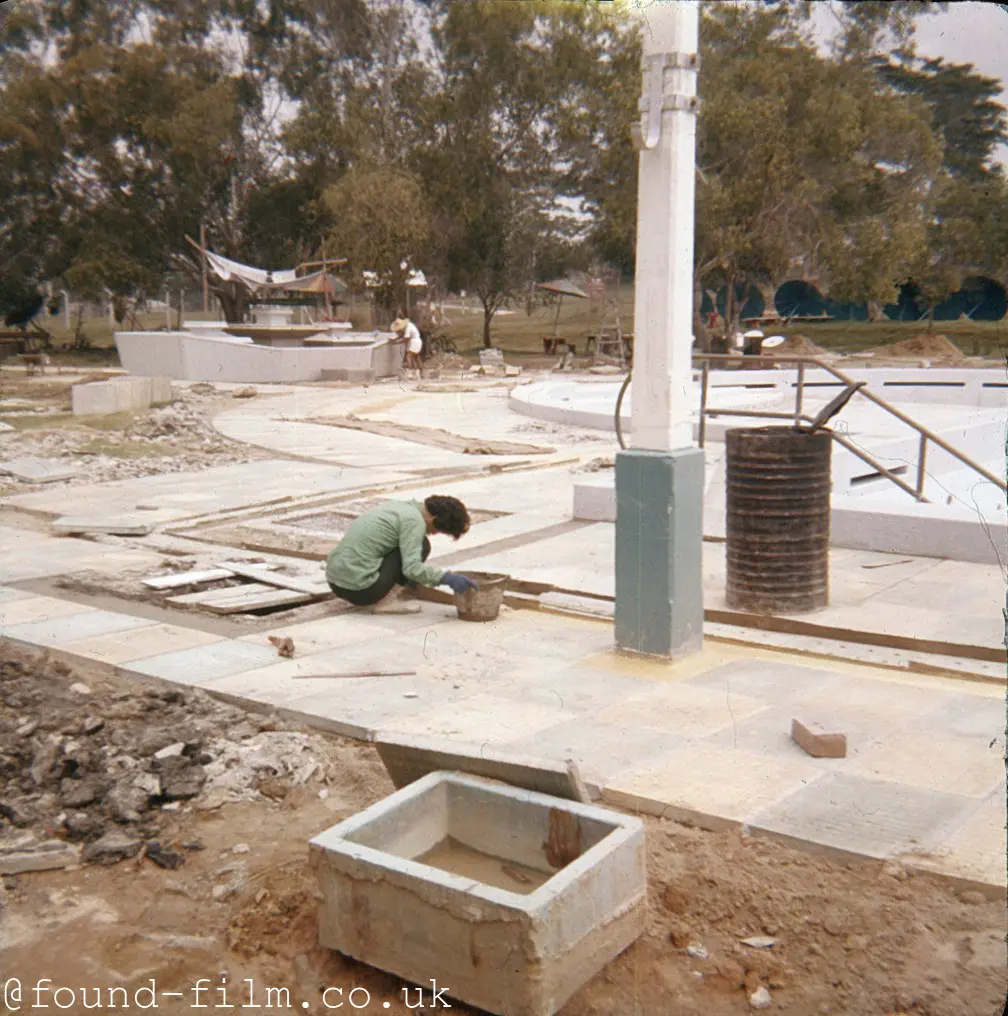 A Stonemason or builder laying paving slabs - c1960