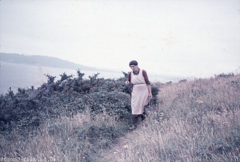 A Woman walking along a coastal path in the mid 1950s