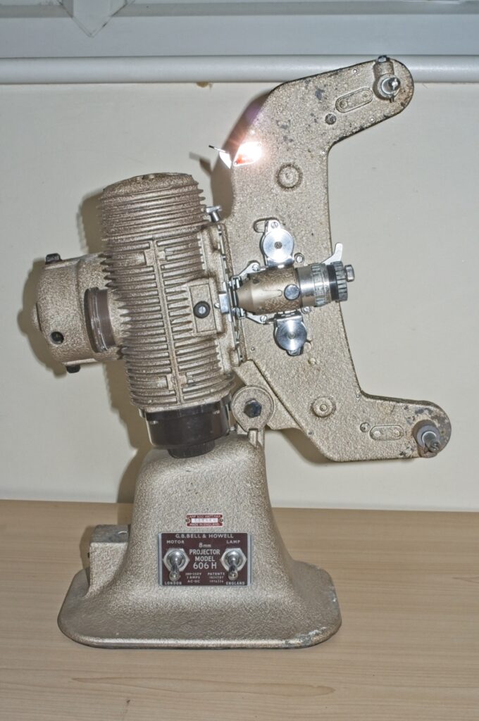 An image of a vintage Bell & Howell 8mm projector model 606H : Front side view of projector