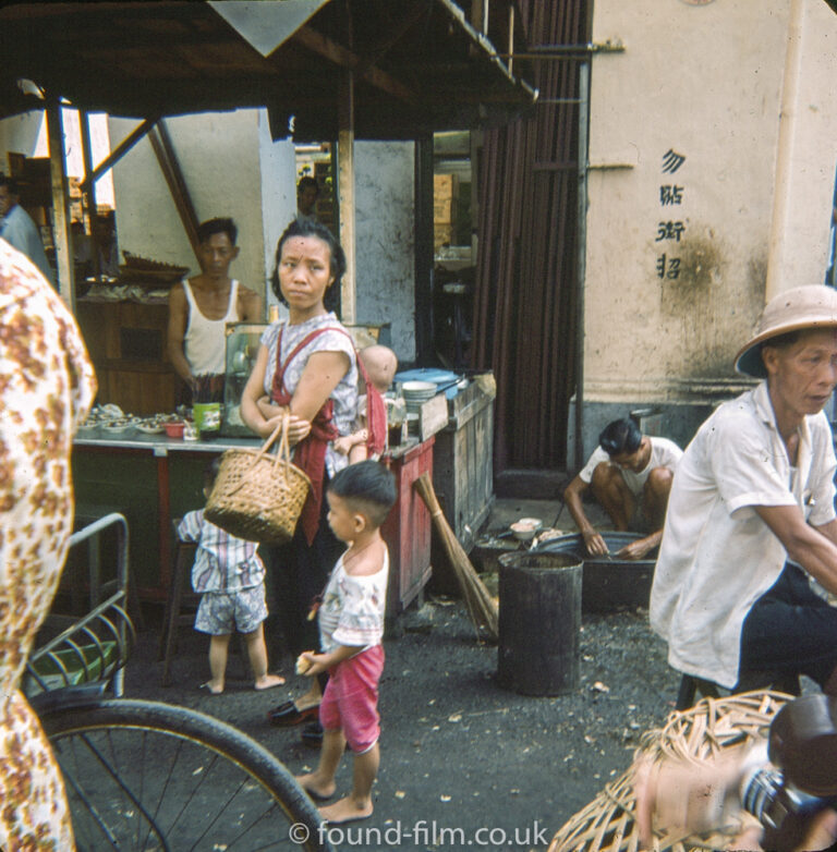 Candid shot of a woman and her children in Singapore market