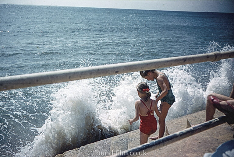 Two young children at the edge of the sea