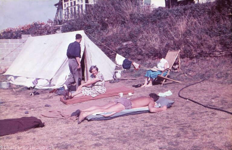 Colourful photo of a family camping in the 1950s