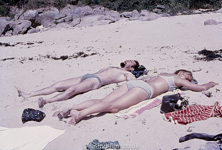 Couple sunbathing on a sunny beach