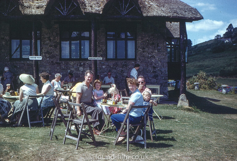 Family enjoying tea in a thatched cafe