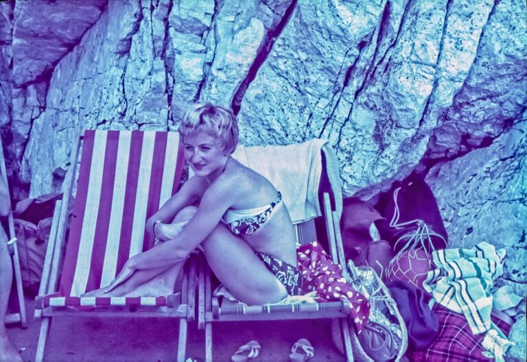 A Girl sitting across two deckchairs