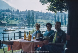 group enjoying a beer by the lake