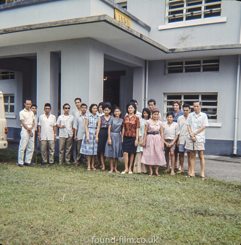 Group posing outside building in Singapore in the early 1960s