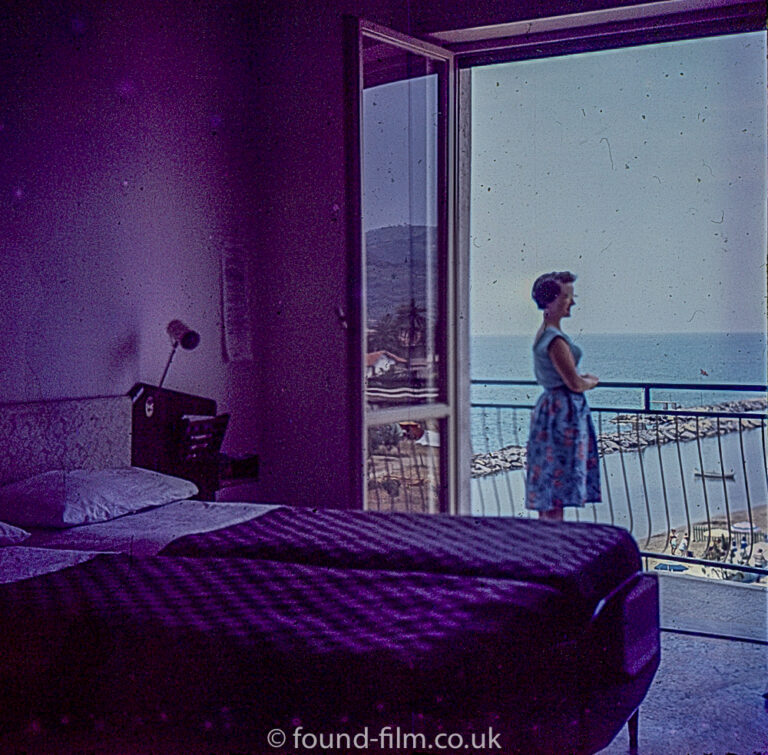 Hotel Bedroom with woman on Balcony