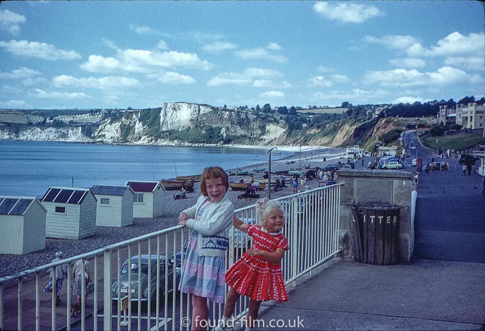 Two little girls standing by a railing
