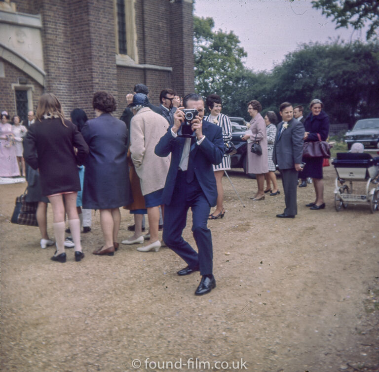 A Man at a wedding with a camera