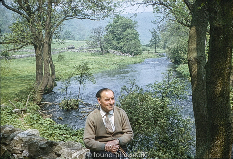 Portrait of an man sitting by a river