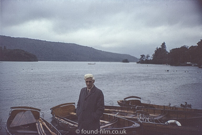 Portrait of a Man standing in front of boats