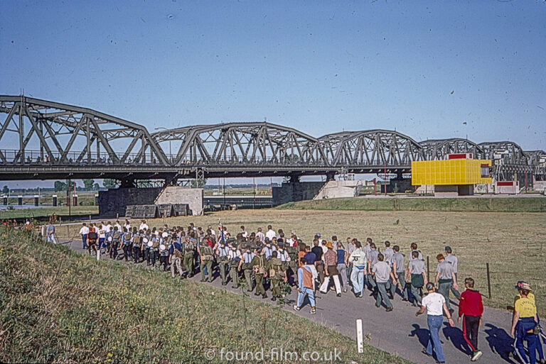 Crowd walking past multi-section steel bridge, Oct 1976