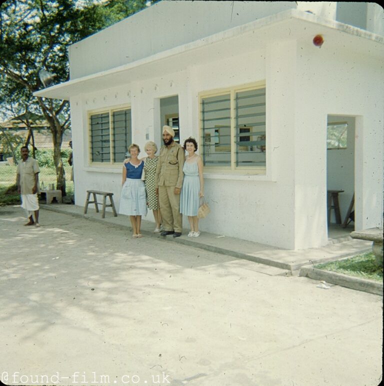 People standing by an office at RAF Seletar