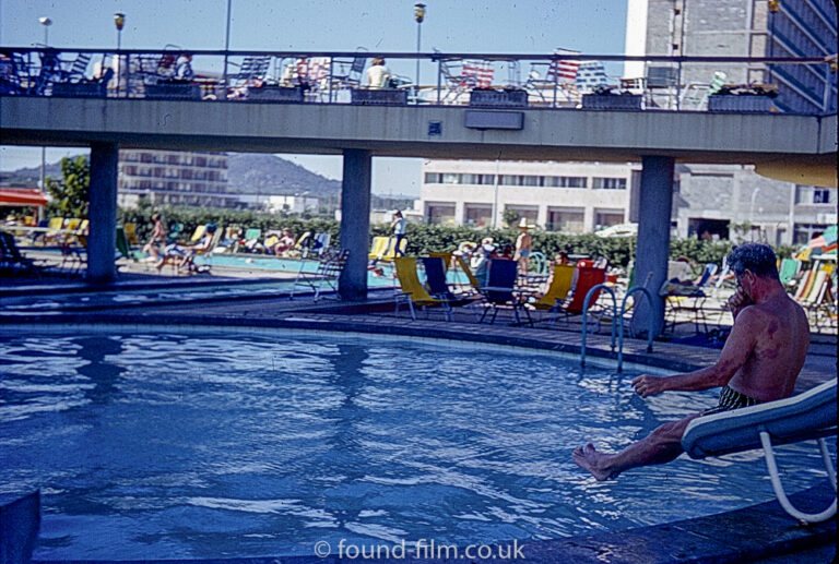 Man on water slide at a Swimming pool in July 1966