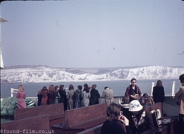 Tourists on a boat by white cliffs