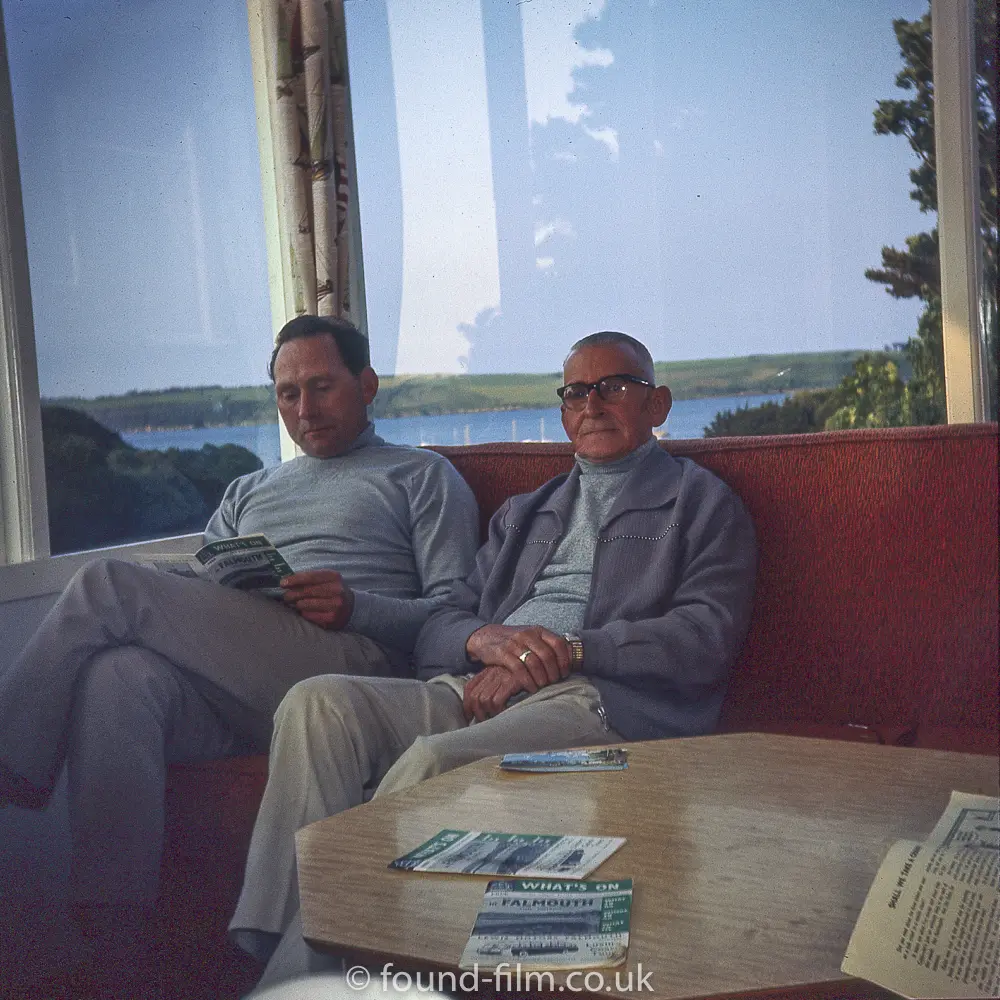Two men reading magazines in Falmouth