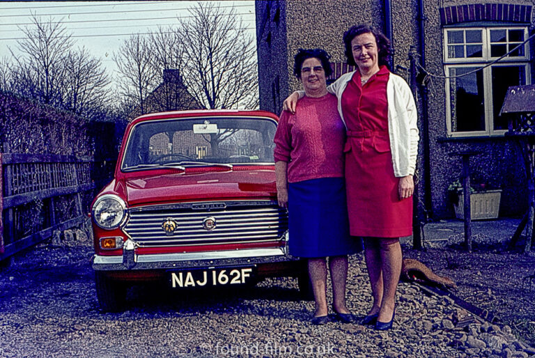 Two women and their red Austin 1100 car