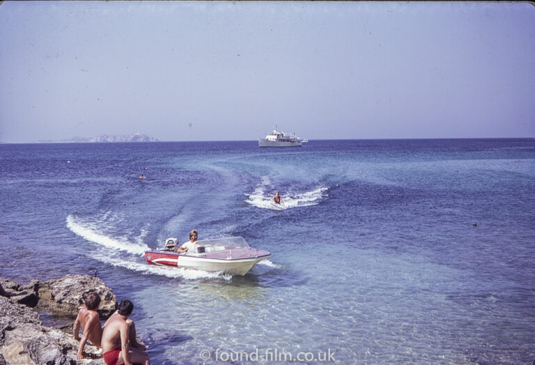 A woman water skiing close to the shore in October 1971