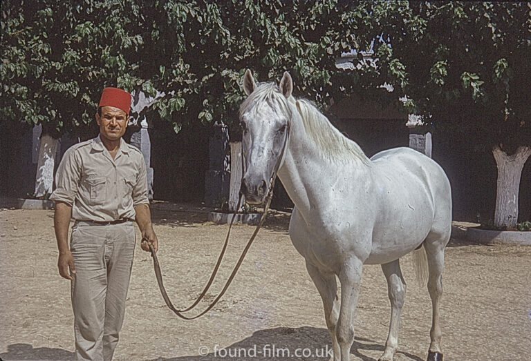 Man wearing a Fez with a White horse, September 1970