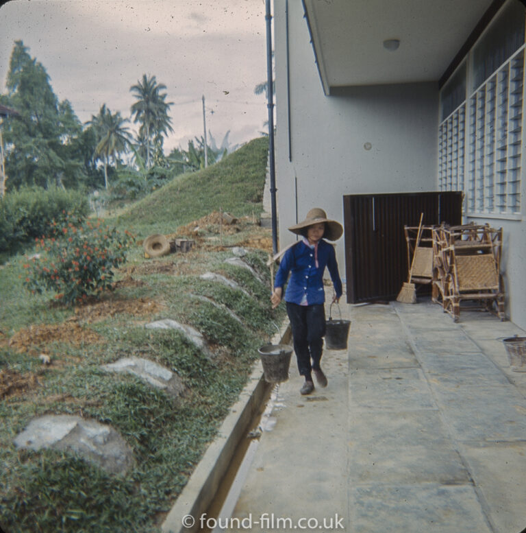 Woman carrying water using a shoulder carrier