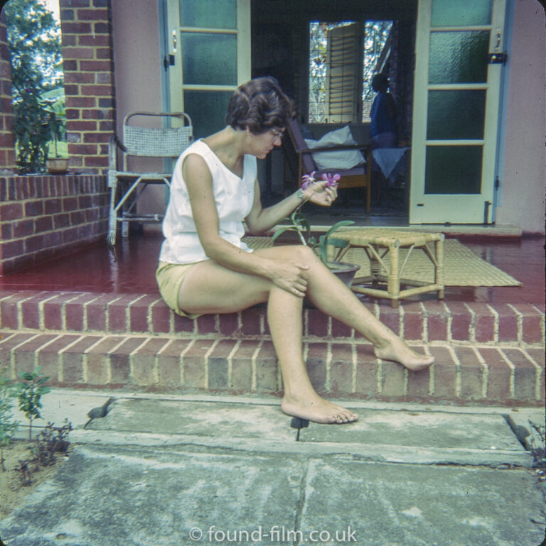 Woman on the steps of a serviceman’s quarters at RAF Seletar early 1960s