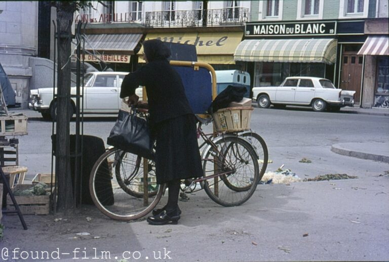 Woman with a bicycle in France, late 1960s