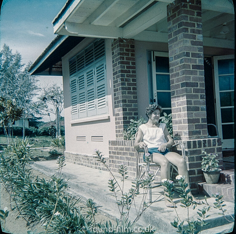 Woman sitting in front porch at Seletar