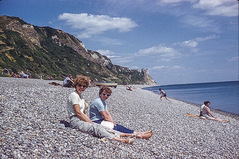 Women sitting on a pebble beach