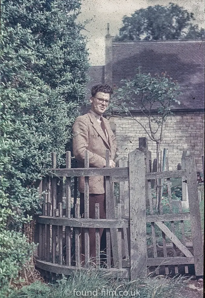 A young man posing by a church gate