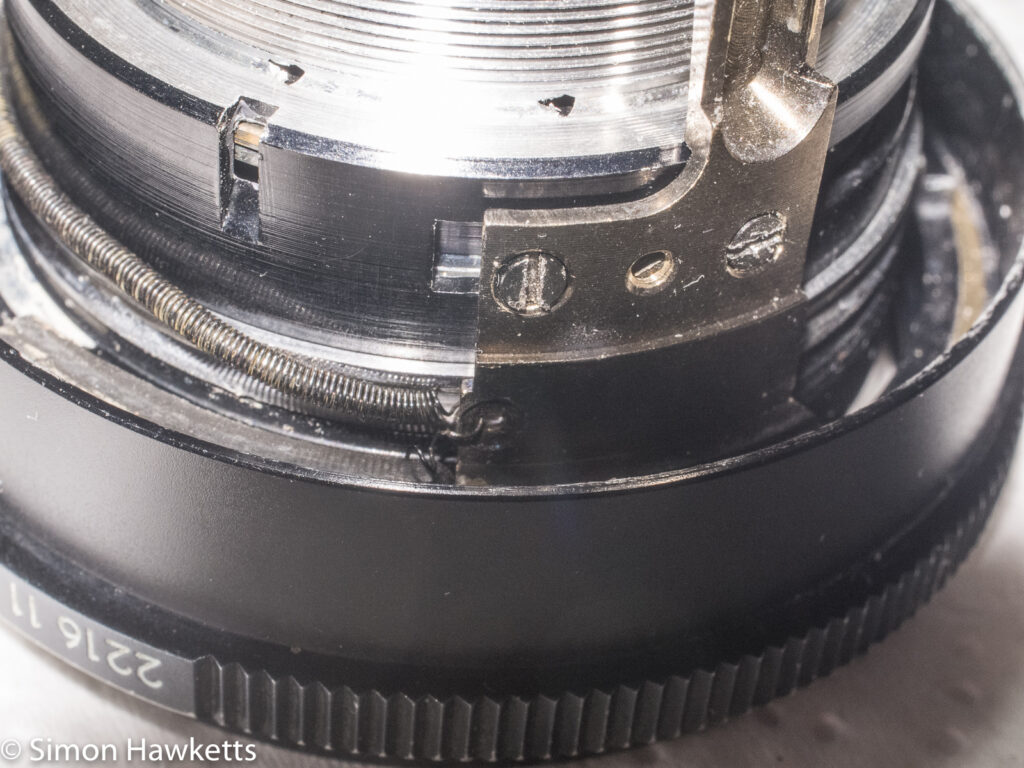 Auto Takumar 55mm f/2.2 strip down - spring reattached to the aperture actuator