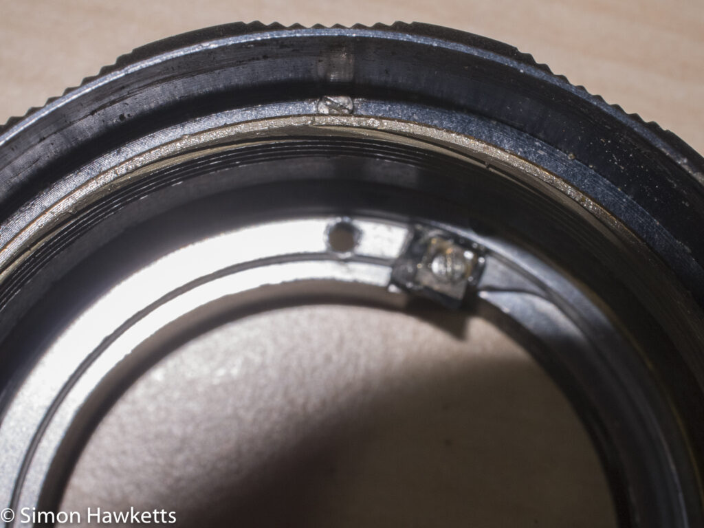 Auto Takumar 55mm f/2.2 strip down - Three screws hold the focus scale to the focus adjust ring