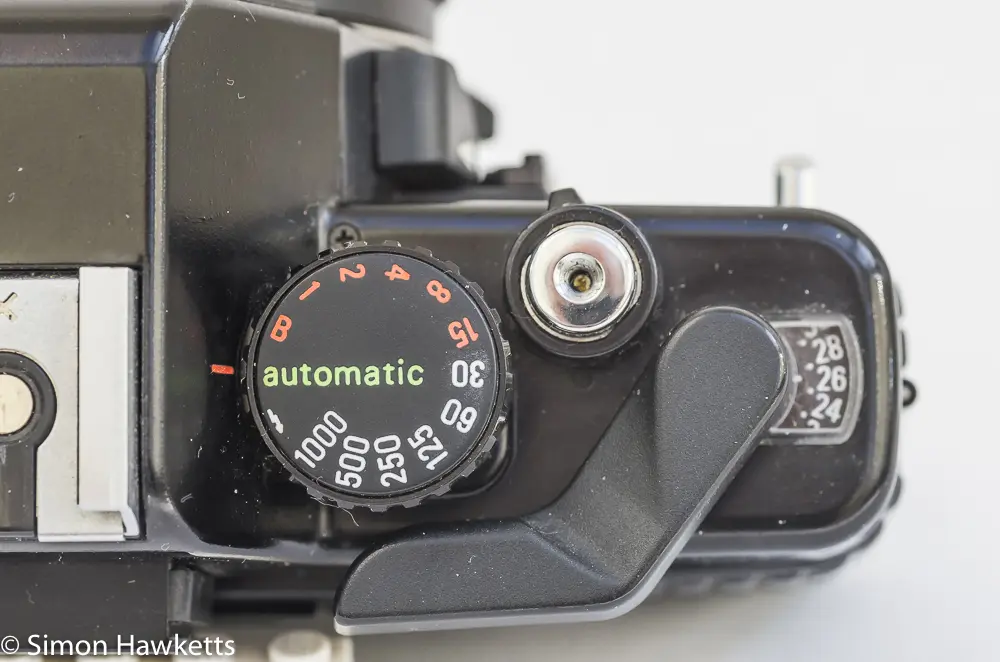 Detail shot of the Praktica B200 shutter speed/mode dial, shutter release and lock, frame counter and film advance