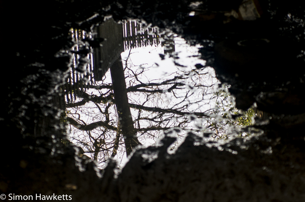 helios 85 to 210mm auto zoom sample picture reflection in a puddle under the railway line