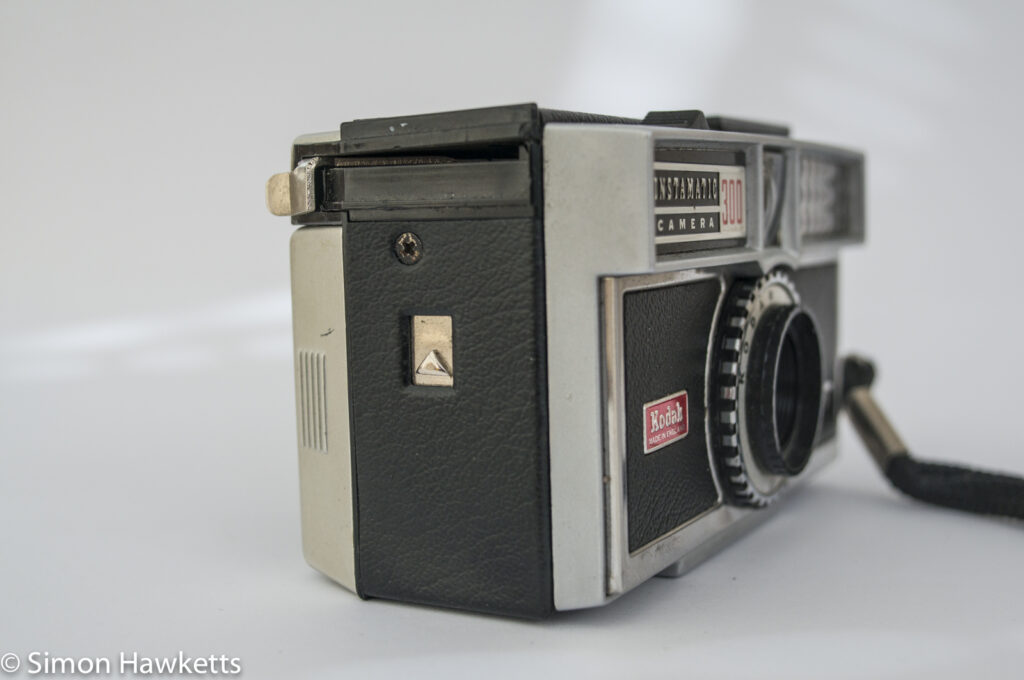 Kodak Instamatic 300 126 film camera showing rear door release and film advance