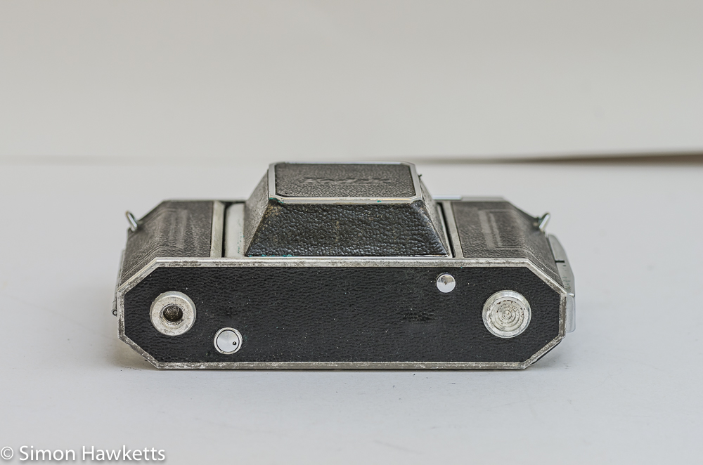 Kodak Retina IIa 35mm rangefinder camera bottom view showing the rewind button, the lens release button and the tripod bush