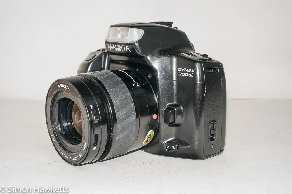 Minolta Dynax 300si 35mm autofocus camera - side view showing af/mf switch and lens release