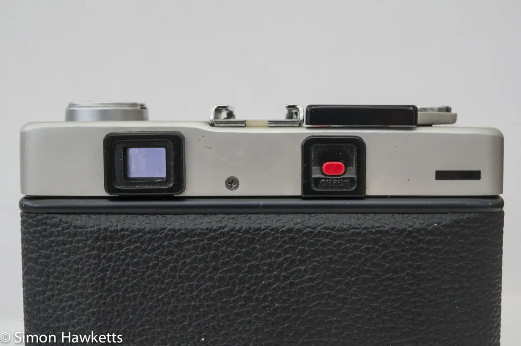 Minolta Hi-Matic F 35mm rangefinder camera showing battery check button